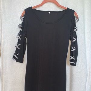 A black fitted dress with silver criss-crosses